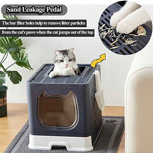 Cat sitting in a top-entry litter box with sand leakage pedal feature.